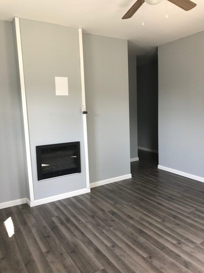 Living room with electric fireplace - 828 W Roache St Unit TBD