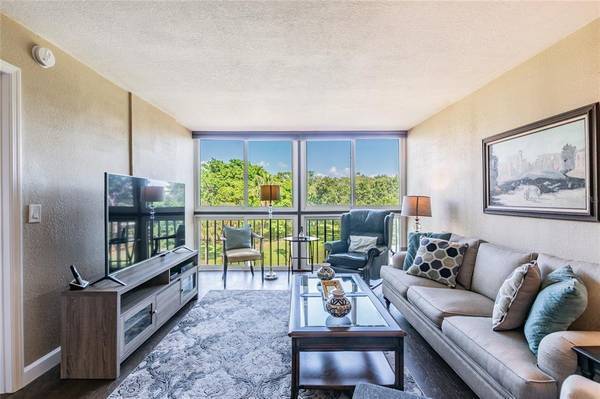 Living room view of 9th tee - 800 Cove Cay Dr Unit 4A