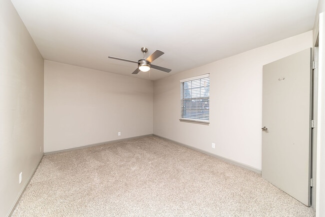 Cozy bedroom with carpet & ceiling fan