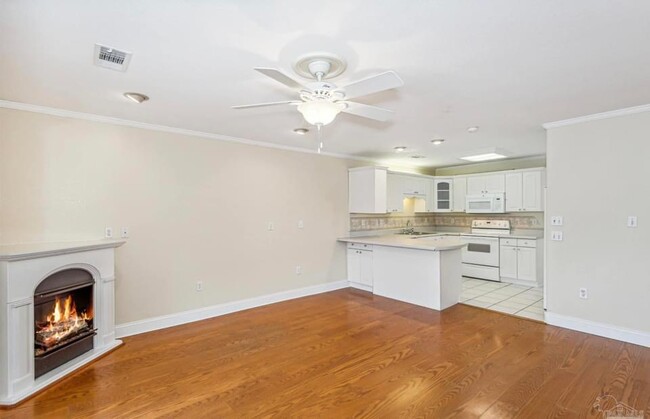 Great room with fireplace and view of the courtyard - 201 Pensacola Beach Rd Townhome