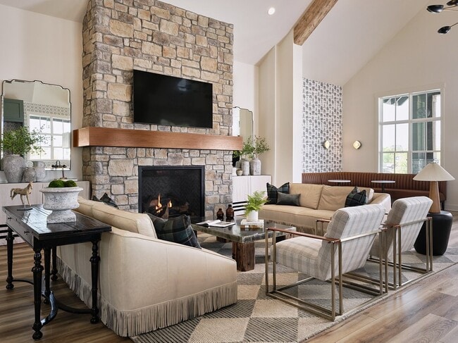 Clubhouse living room with ample seating, fireplace and TV.