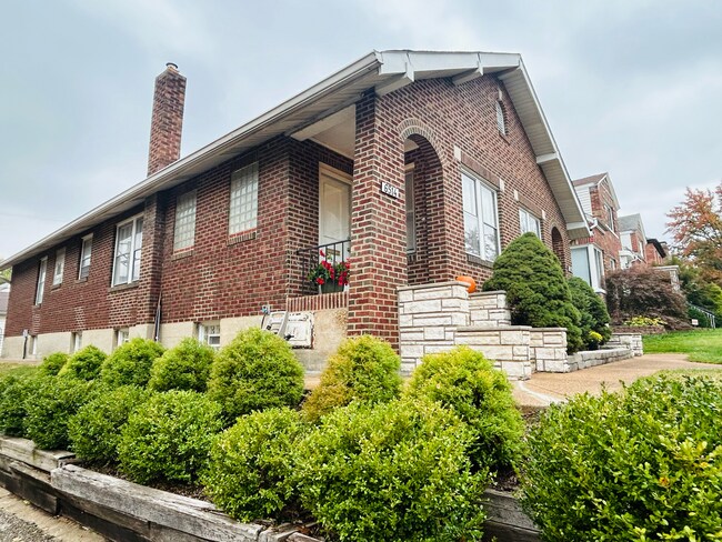 Landscaped side view of property - 6516 Oleatha Ave House