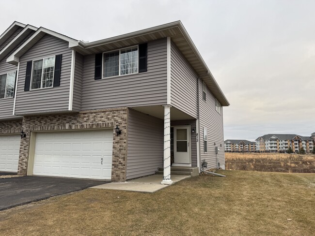 Front with a 4 car driveway and a 2 car garage - 813 Alysheba Rd Townhome