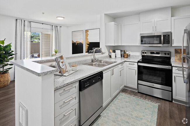 Upgraded kitchens feature new countertops, stainless steel appliances and shaker-style cabinets - Benson Downs Rental