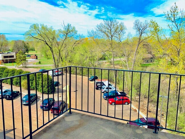 SELECT UNITS: Balcony with creek & parking lot view