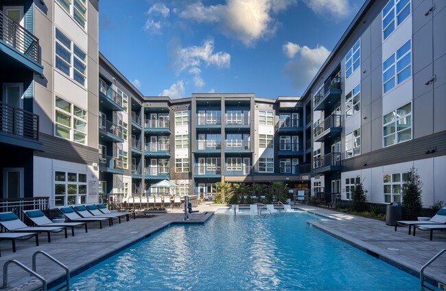 Pool Deck Featuring Lounge Chairs, Courtyard Views, and Walk-Up Access - NoDa Flats Rental