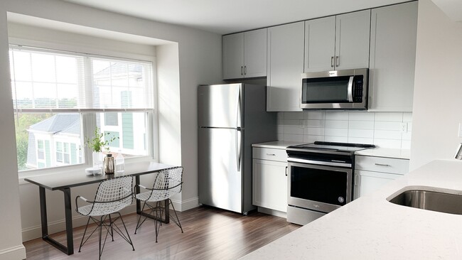 Our renovated kitchens offer brand new cabinetry, quartz countertops, and stainless steel appliances - Windsor Village at Waltham Townhomes