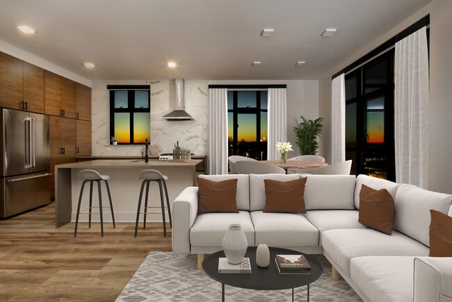 Kitchen, living, and dining areas with hard surface flooring throughout and floor-to-ceiling windows
