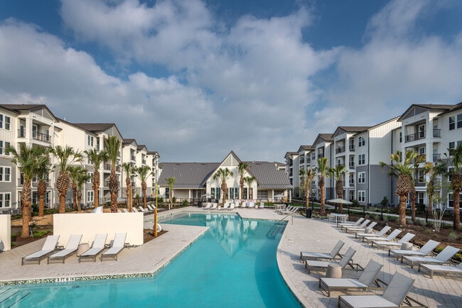 Enjoy the serene poolside experience at this luxury apartment complex, perfect for relaxation and leisure.