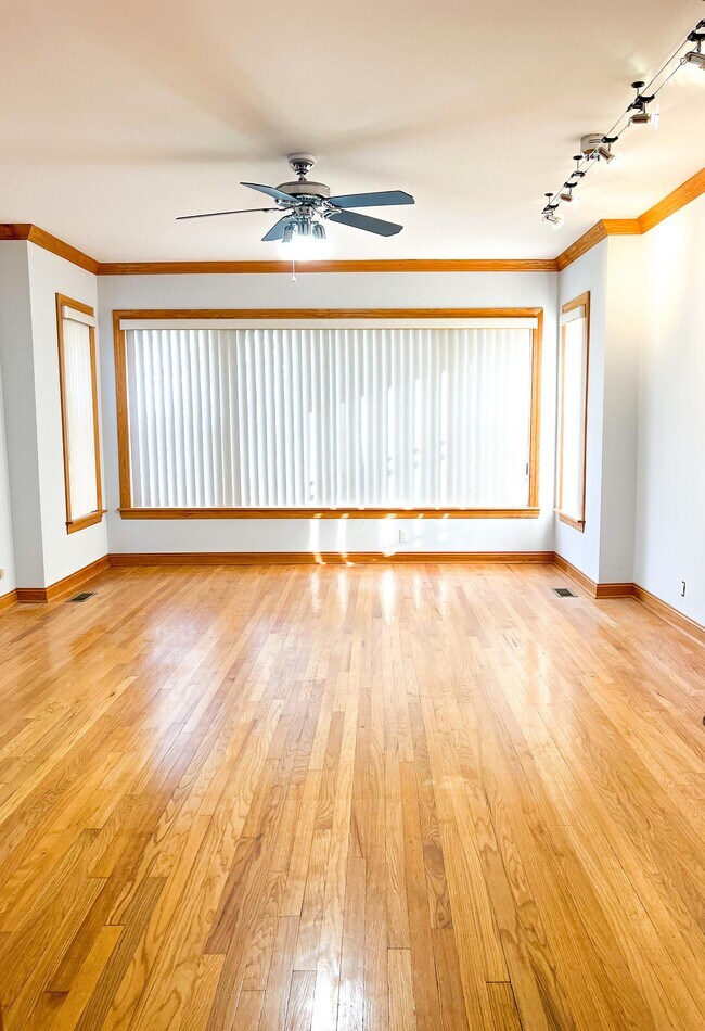 Living room with hardwood floor - 6042 W Miami Ave Unit 1st