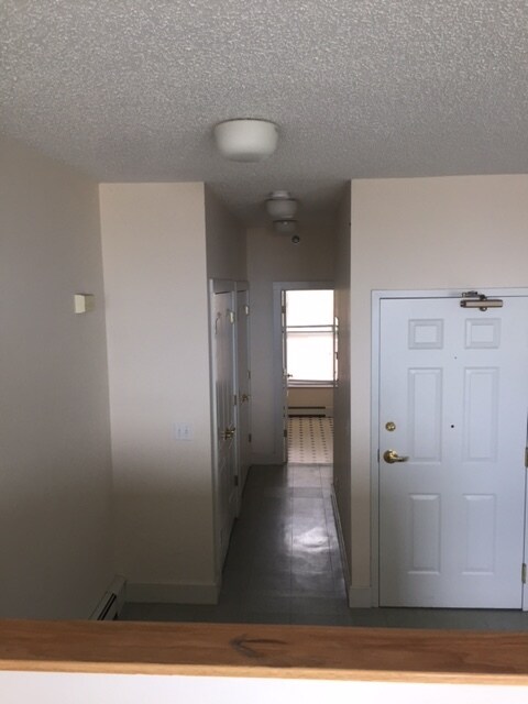 front door and hallway to bedroom and bathroom - 22 W 3rd St Unit C