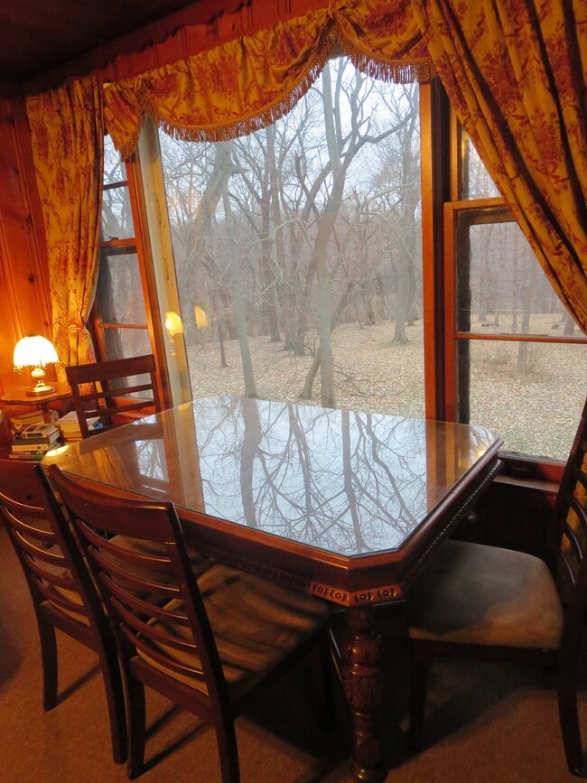 Living room with picture window overlooking forested area/large yard. - 22 McGrath St Unit .5