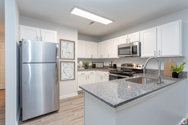 Modern Kitchen with Granite Countertops & Stainless-Steel Appliances - Timber Woods Apartments