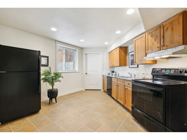 kitchen and door to laundry & unfinished storage - 1005 Laporte Ave Unit Basement