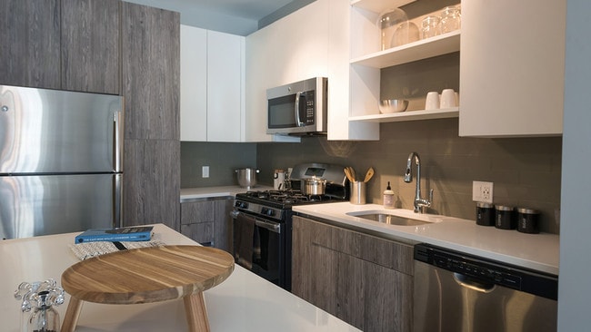 Two tone cabinetry with ample storage options including pantry