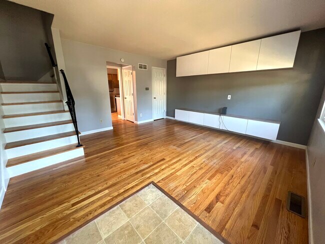 Living Room with Installed Floating Entertainment Center - 2121 Prairie Glen Plz Townhome