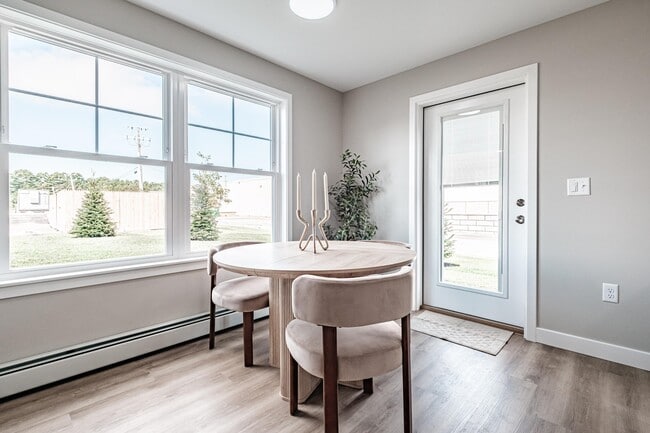 Designed for everyday living, this bright and inviting space features large windows, comfortable finishes, and an open dining area that feels right at home.