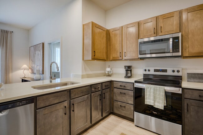 Modern kitchen with sleek cabinetry and contemporary finishes at Sageland Flats at Brooks