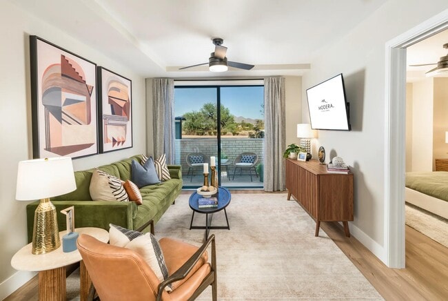 A bright and inviting living space designed for comfort and connection, featuring stylish finishes and a private patio that invites the outdoors in. - Modera Scottsdale