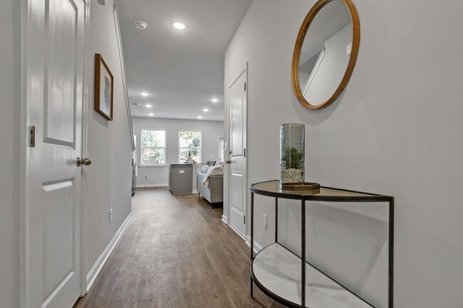 Inviting entryway featuring durable wood-style floors - Covey Homes Kirkland