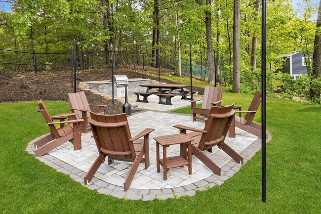Unwind in the serene outdoor space at Eagle Rock Apartments at Manchester, complete with cozy seating and a fire pit surrounded by lush greenery. Perfect for gatherings or quiet moments. Schedule your visit today and find your ideal escape!