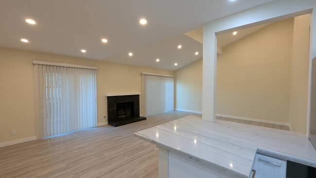 living room with fireplace - 21500 Califa St Townhome