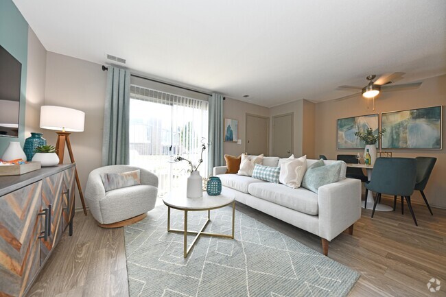 Spacious living room with hardwood-style flooring - The Manning Apartment Homes