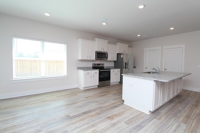 Photo - Don’t Miss This 4BR Home — 3-Car Garage, Modern Interior, Open Layout & Community Pool in Prime 9...