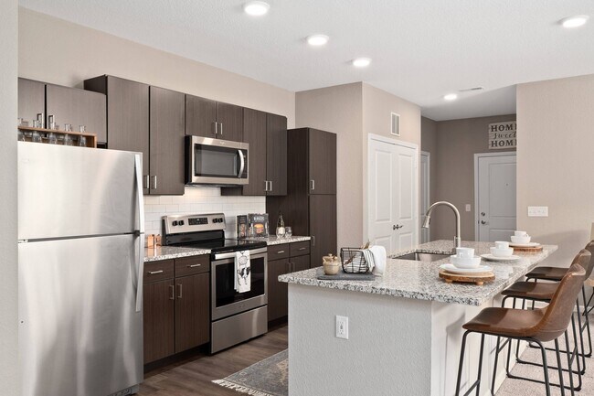 Kitchen with stainless steel appliance and island