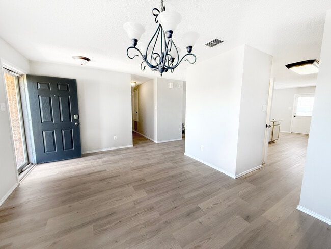 Front entry/formal dining looking down hallway to secondary beds/bath. - 1419 Windy Meadows Dr