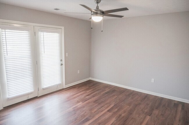 The spacious bedroom with patio access - Willow Green Apartments