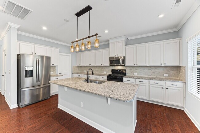 Photo - Classic finishes paired with an open, versatile layout!