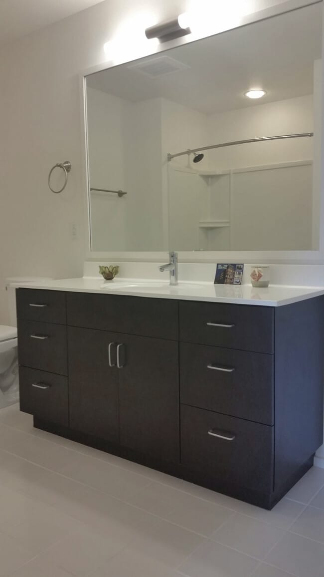 Refined Bathrooms with Expansive Storage and Vanity