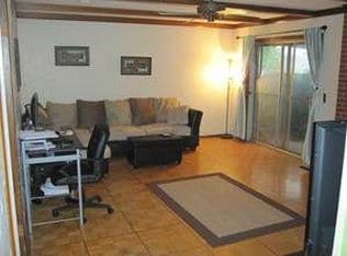 living room with patio door, gas fireplace and wood floors