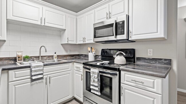 Elegance flows with designer kitchens featuring subway tile backsplash.