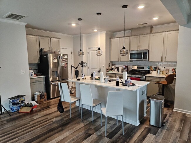 Modern townhome with high-end finishes throughout, minutes to 540 and walkable to great shopping.