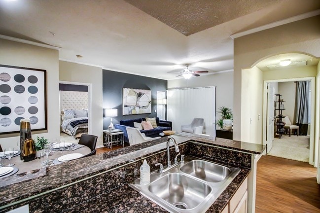 Kitchen are and living room with cozy dining nook, double sink and hardwood style flooring