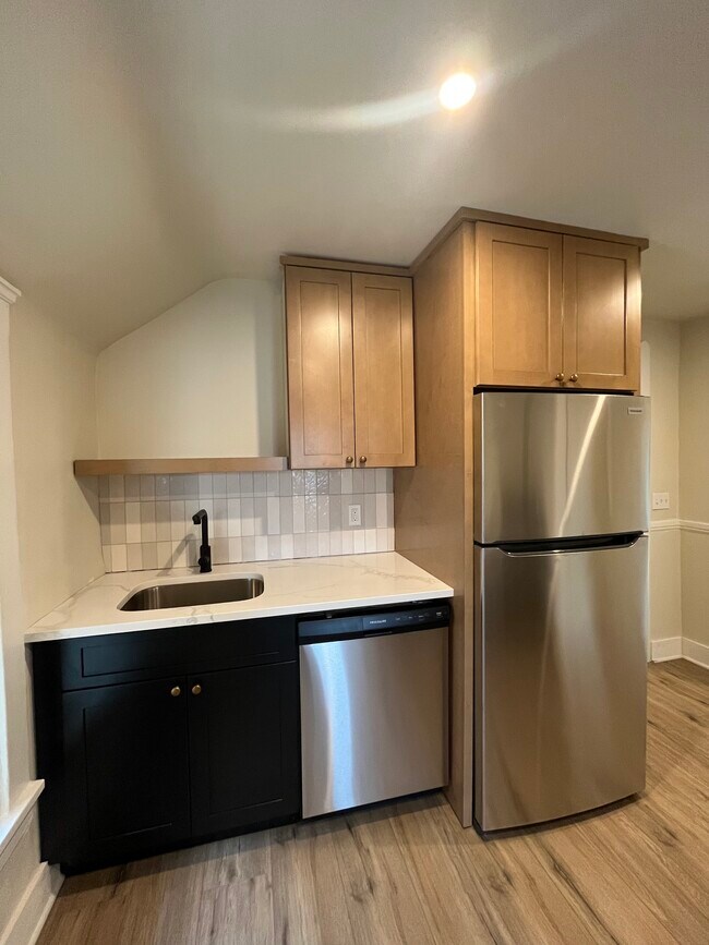 Kitchen includes newly installed cabinets, counters, and appliances - 1382 E 43rd St Apartments