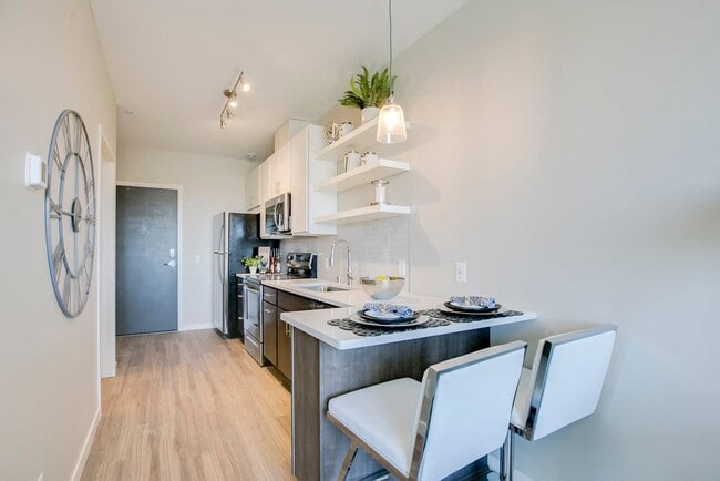 The kitchen in this studio layout offers a breakfast bar with seating space.