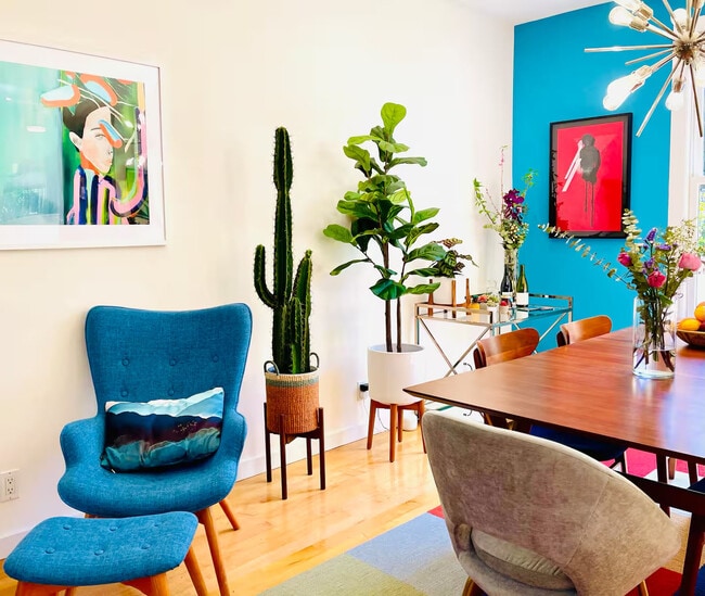 Midcentury furniture, art, plants, and a vintage mirrored bar cart. - 328 Harriet St