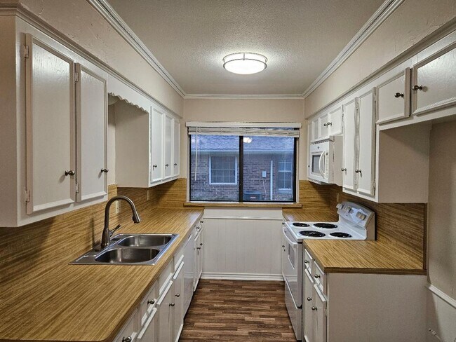 Photo - Three bedroom and two bathroom nicely remodeled with new flooring. Large wood fenced backyard