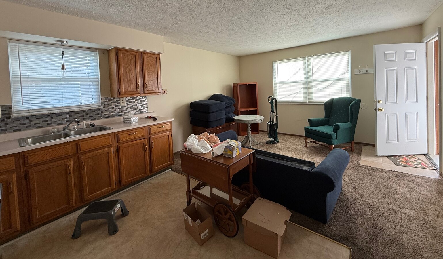 Living room and kitchen area. Shown furnished. Apartment rented unfurnished. - 211 Walnut St Unit 202