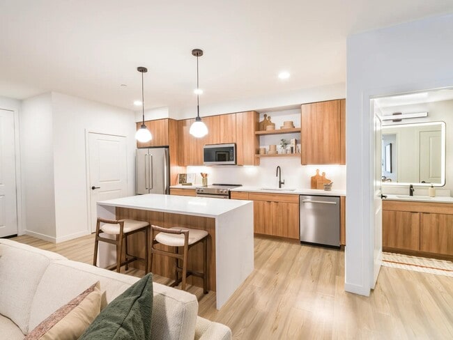 Sleek cabinetry and warm wood tones bring balance and style to every kitchen at Modera Higley Commons.