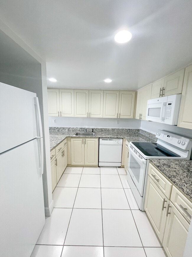 Kitchen with Granite Countertops with Modern, White Plywood Cabinetry with Self-Closing Hinges*