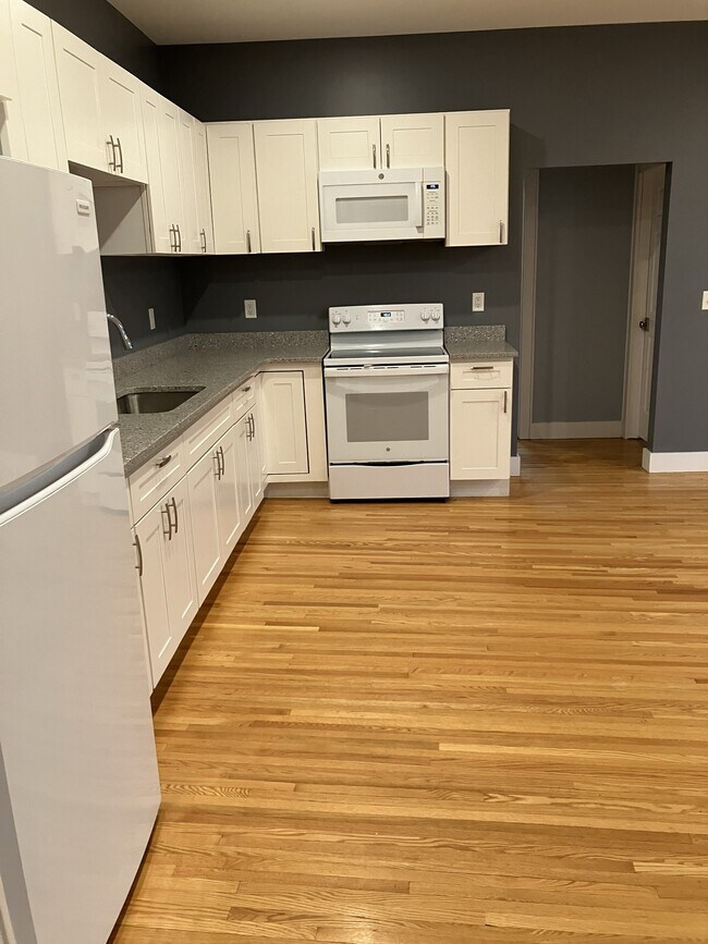 Stove, opening to hallway - 10 S Lake Ave Unit Apt B