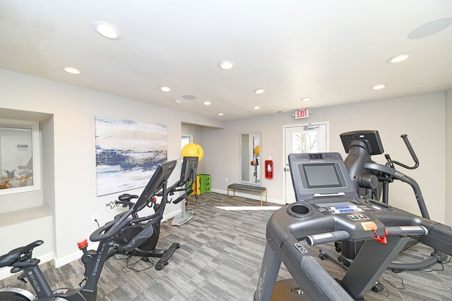 Elevate your workout experience in this chic and well-equipped fitness room.
