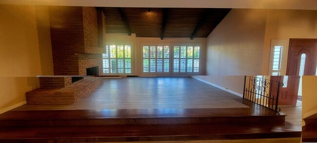 Living room with brick fireplace - 16139 Ladera Piedra Way