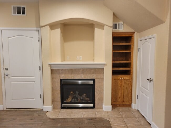 Fireplace, bookshelf & coat closet - 5775 W 29th St Condo Unit not given