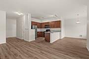 Spacious open-concept kitchen and living area at Port Landing at Fife in Fife, WA.