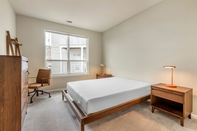Furnished+ apartment homes feature queen bed with mattress, dresser, nightstands, lamps, and an office desk and chair (Representative Image – exact items and style of furnishings may vary)
